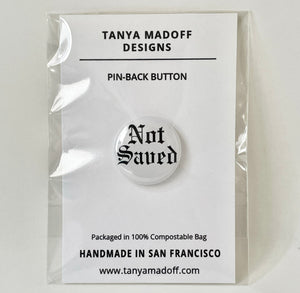 PiNot Saved 1" Pin Back Button packaged on card stock in compostable see through, flat plastic bag