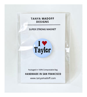 I Love Taylor, 1 inch extra strong magnet, in honor of Taylor Swift, with black lettering and red heart on pale blue background, packaged on recycled paper, in 100% compostable clear glassine bag