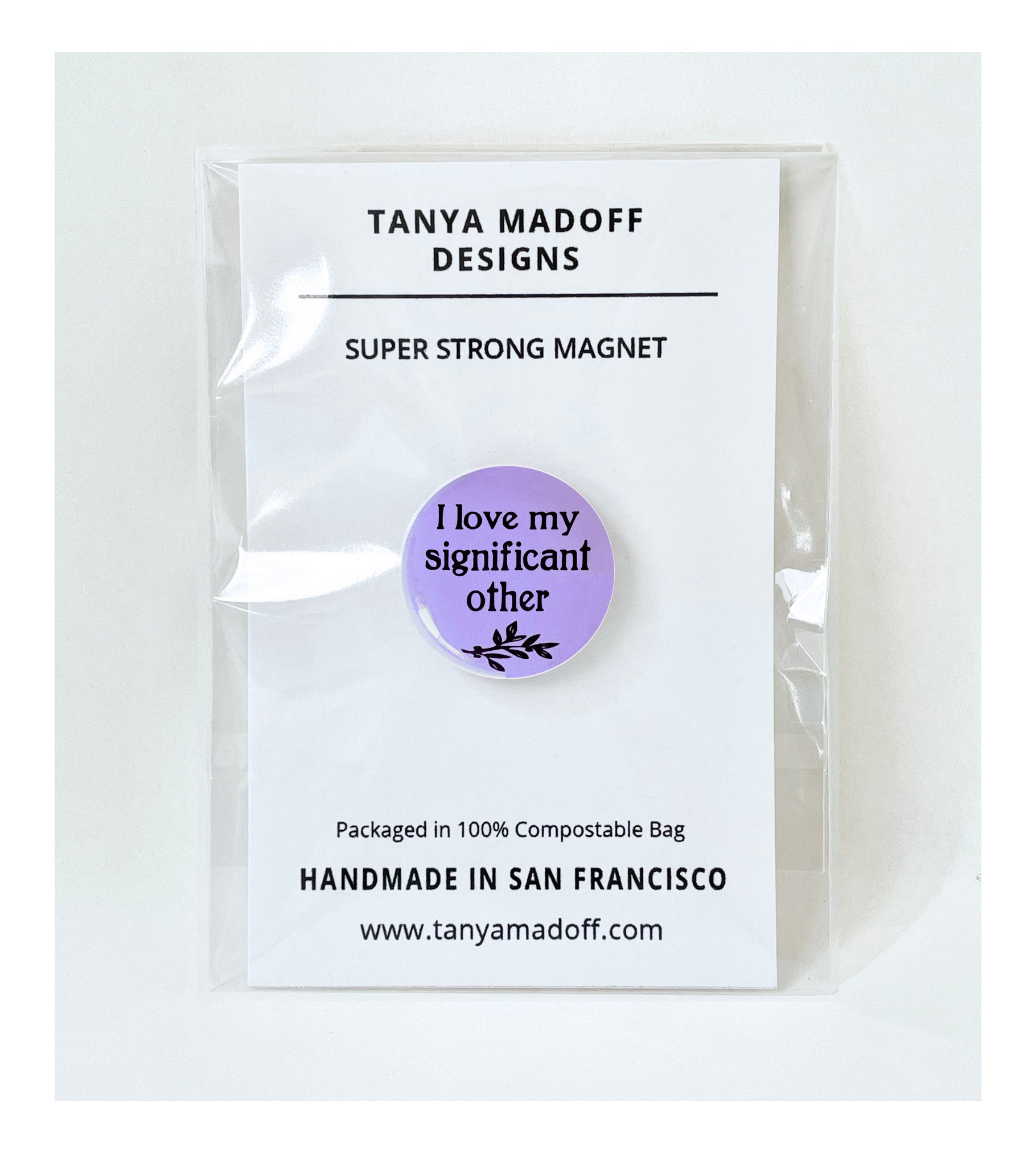 I love my significant other, 1 inch extra strength magnet, in black lettering and small branch with leaves on purple lilac background, shown packaged on  recycled paper card in 100% compostable clear bag.