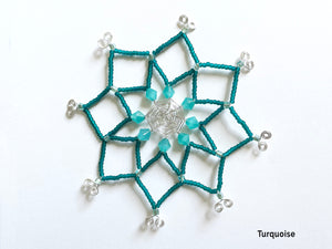 Turquoise and silver beaded snowflake ornament. Wire is cut and bent by hand with spiderweb design in the middle. Featuring vintage milk glass and matte turquoise beads.