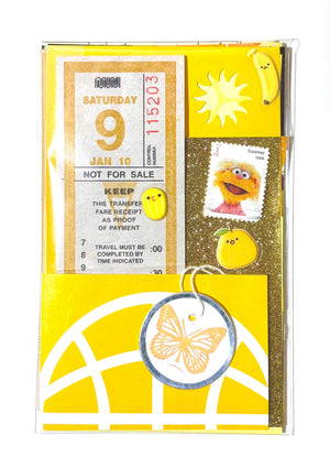 Mystery Ephemera Kit, authentic vintage junk journal kit with different shades and textures of yellow decorative papers, stickers, pompoms, cancelled stamps, etc. 