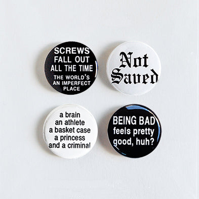 Set of four pin-back buttons with the best quotes from the John Hughes classic 80s movie, The Breakfast Club. Includes Not Saved, Screws Fall out All the Time, A Brain, an Athlete..., and Being Bad, Black. Lettering on white background and white lettering on black background. 